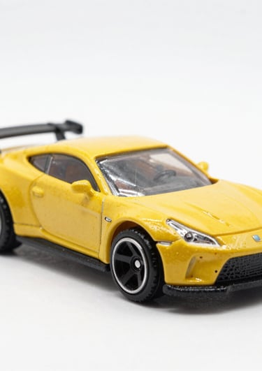 Close-up of a rugged RC crawler toy climbing over rocky terrain.