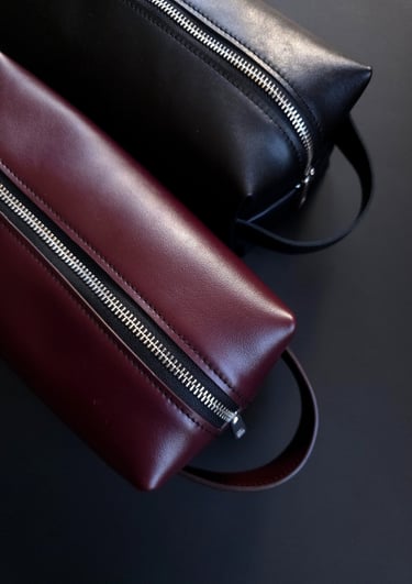 Burgundy and black leather toiletry bags 