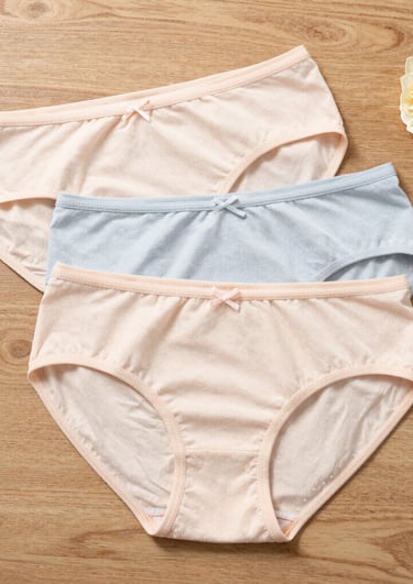 Rose gold themed lingerie set displayed on a soft fabric background