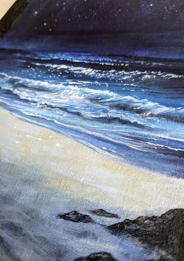 Wide expanse of night sky, sea, and white sand seen from a dark threshold. Original painting by Geeta Arya.