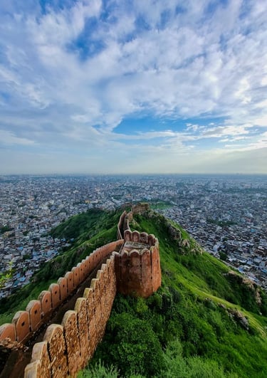 Panoramic view of Nahargarh Fort wall on a green hill overlooking the city of Jaipur, India.