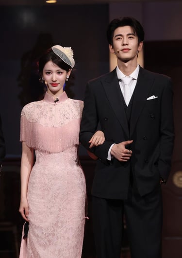 Actors Zhang Jingyi and Zhang Linghe pose in elegant pink lace cheongsam and a black tuxedo.