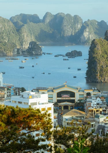 Halong Bay holiday view with limestone cliffs, emerald waters, and boats by Soma Journeys.