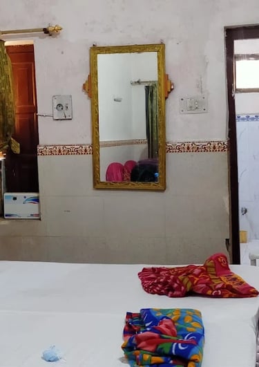 a bed with a white bed and a microwave