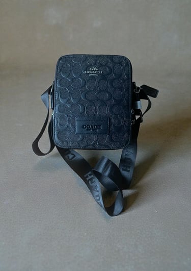 a small black purse with a black and white polka dot pattern