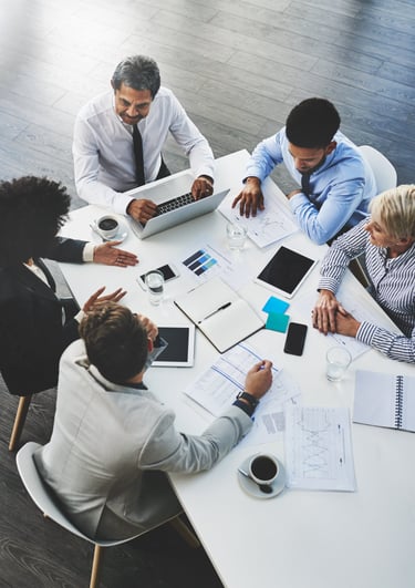 a group of business people sitting around a table