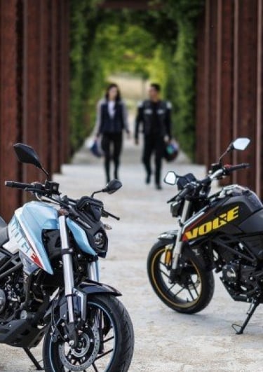 a motorcycle parked on a rocky river bank