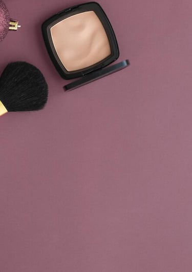 a makeup brush and a brush on a purple background