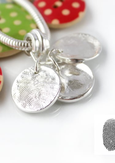 Three silver fingerprint charms. Your family's real fingerprints
