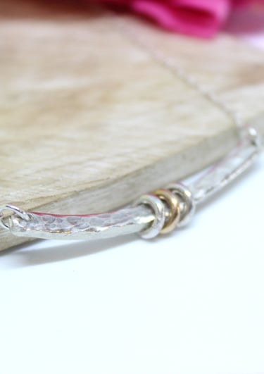 Silver handmade necklace with a bar and 2 silver and 1 gold ring for a 21st birthday. 