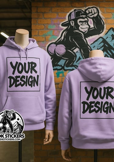 Light lavender custom hoodies with “Your Design” print and ADKstickers.com logo in front of graffiti