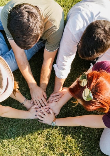 a group of people siting around a group of hands