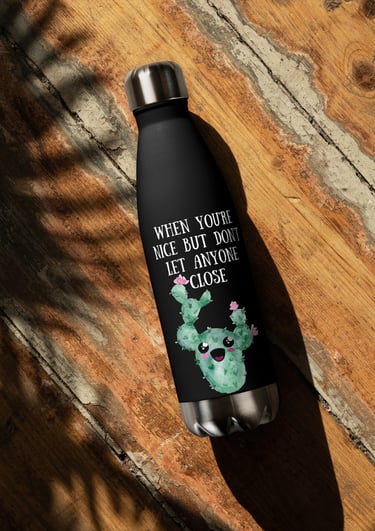 Black cactus-themed stainless steel water bottle on rustic wooden surface.