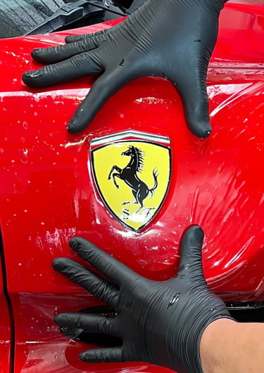 Installation d'un PPF sur le bloc avant d'une Ferrari dans notre atelier en Isère