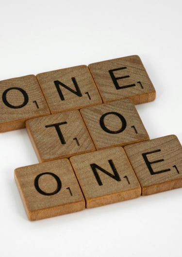 The Scrabble words "one to one" represent the option for one-to-one Spanish lessons to improve skill