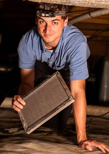 Jayden Kelley replacing a Dehumidifier Air Filter