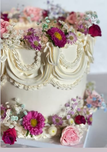 a cake with flowers on top of a white table