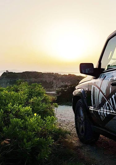 a black jeep parked on a dirt road
