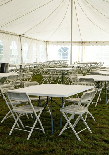 tables and chairs under a tent