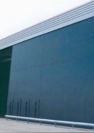 a large industrial warehouse with a large blue door