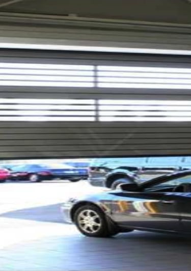 a car parked in a garage with a car parked in front of it