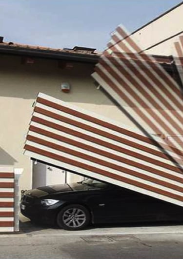 a car parked in front of a house with a large wooden fence