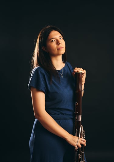 a woman in a blue dress holding a trumpet