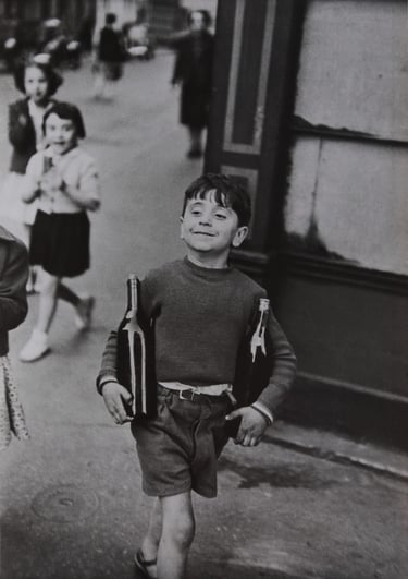 A Cartier-Bresson photo - boy carrying wine bottles