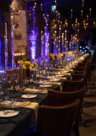 Close-up of luxury dinner table setup with candles and flowers, Fred Art Studio.