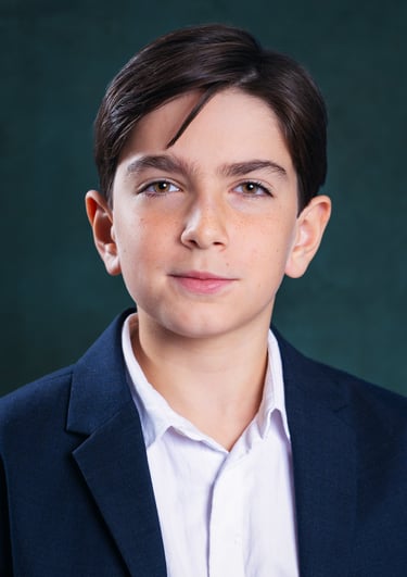 a young boy with a white shirt and a blue jacket