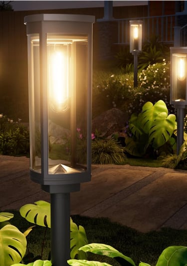 outdoor pathway lights illuminating a garden walkway at night.