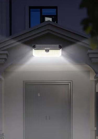 Bright solar-powered motion sensor wall light illuminating a residential front door at night for home security.
