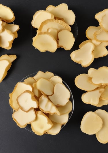 Artistic shot of dried ginger pieces with warm lighting emphasizing their natural golden hues.