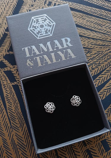 Handmade silver Celtic knot stud earrings in a branded Tamar and Talya jewelry gift box.