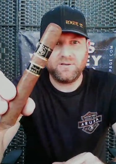a man in a black shirt and a cigar