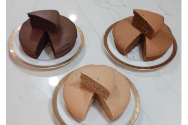 Gluten free cakes by Only Oats with a slice cut from each in chocolate and vanilla.
