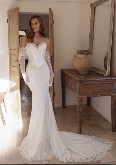 a woman in a white dress with a long sleeved dress