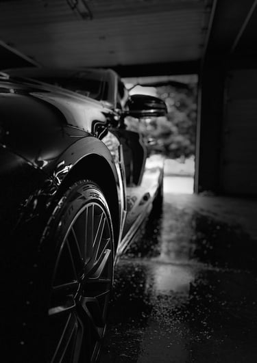 Sparkling black sedan after a premium wash and rinse.