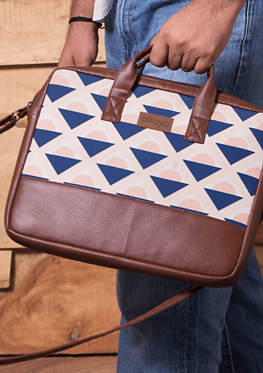 a man holding Akaya India's handmade messenger bag