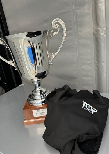 Polished silver trophy and black Torrino Padel Club vest awarded at the 2024 Italian Padel Championships.