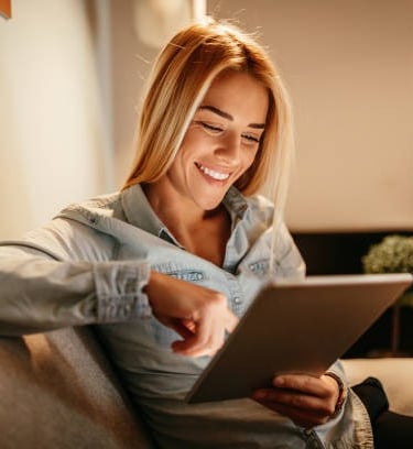 a woman sitting on a couch with a laptop