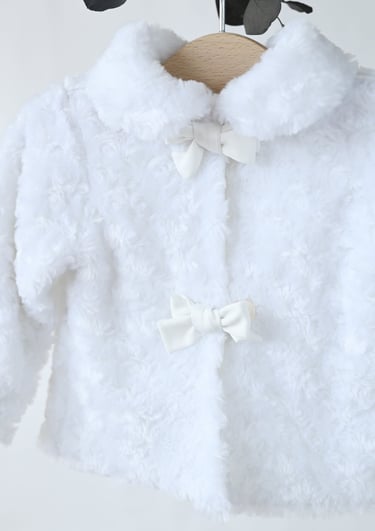 a white fluffy white jacket with a bow tie