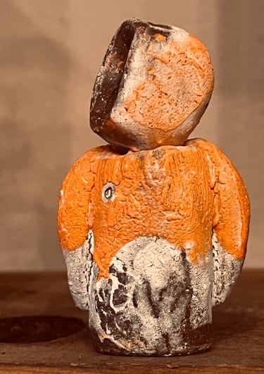 Handcrafted orange and charcoal ceramic totem sculpture with a textured rustic finish by Sundara