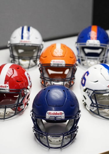 Close-up of a Denver Broncos and Philadelphia Eagles autographed Riddell mini helmet side by side on a wooden display shelf.