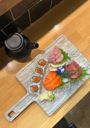 a wooden cutting board with sushi and sushi