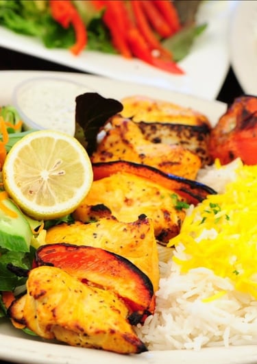 a plate of Mediterranean food with rice and vegetables