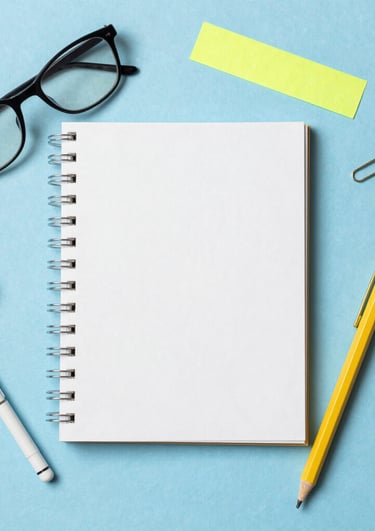 Close-up of colorful hair accessories and stylish sunglasses on a bright background.