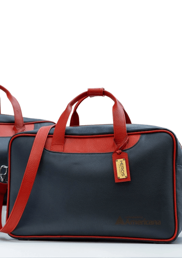 two bags of luggage with a red and blue one by heros leather
