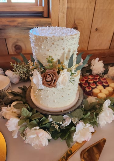 a cake with flowers and a cake on a table