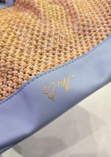 Hot foiling initials on leather bag at Saks Fifth Avenue by NYC calligrapher Handwritten by Belle.